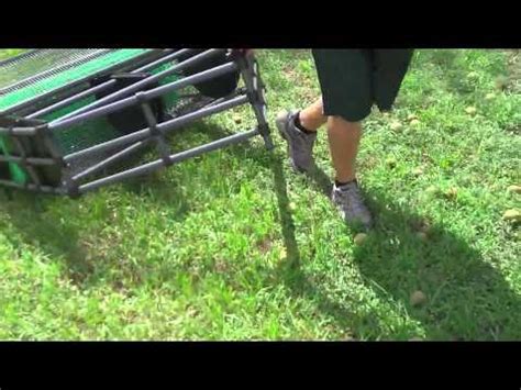 how to pick up walnuts skid steer|baganut walnut picker.